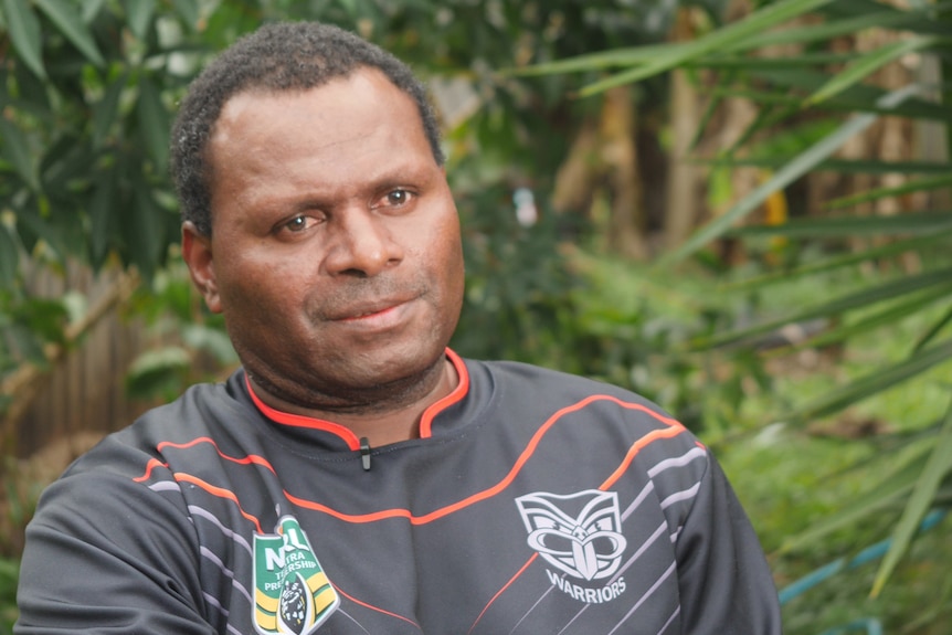 PNG man wearing a football jersey.