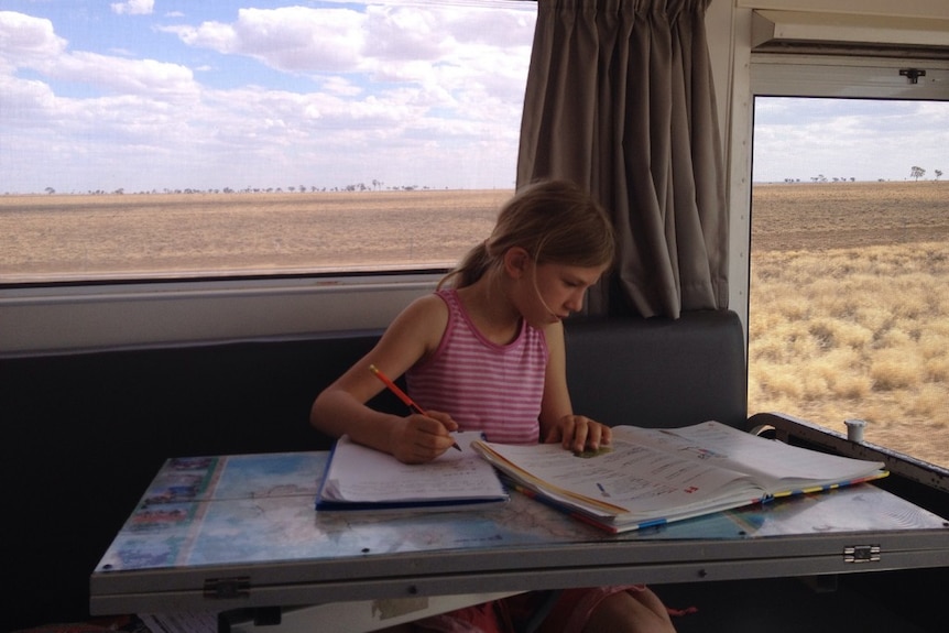 Jade Catania studying in her family's home on the road.