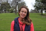Michelle Bridges looks towards the camera while standing in Melbourne's Royal Botanic Gardens.