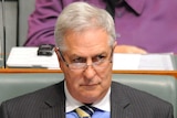 Don Randall listens during question time in the House of Representatives.