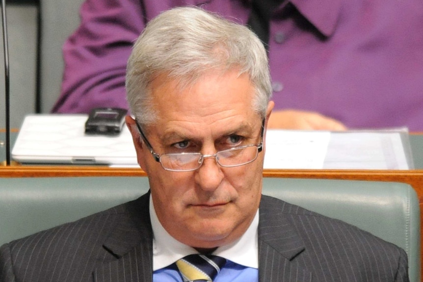 Don Randall listens during question time in the House of Representatives.