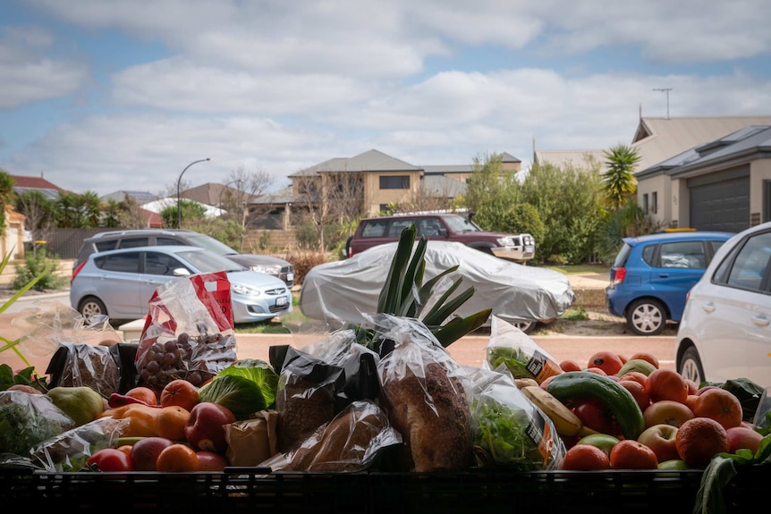 Hamper of food - bread, fruit and vegetables, in suburban garage