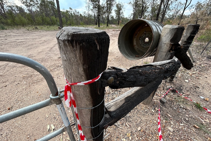 Fire has scorched the timber posts on the fence of the Train's property at Wieambilla.