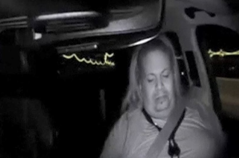 A woman looks down while inside a self-driving Uber just before a fatal crash.
