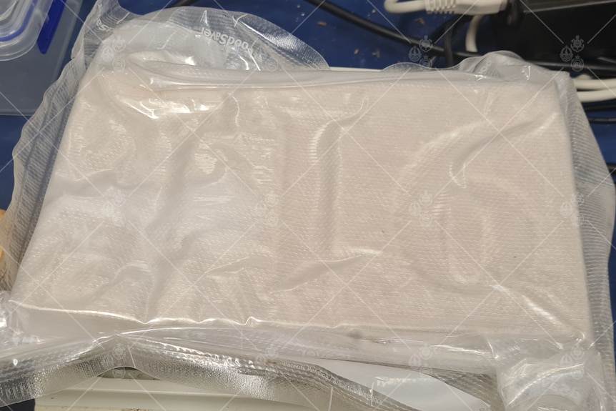 A brick of cocaine inside a clear plastic bag.