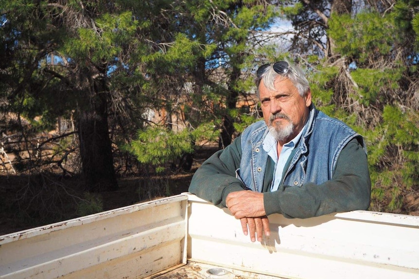 Farmer Neville Michael leans against his ute.