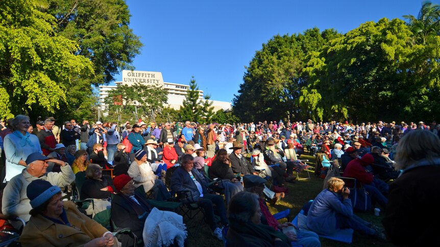 A crowd listens to a special outdoor broadcast of Australia All Over with Macca at Southbank Parklands in Brisbane.