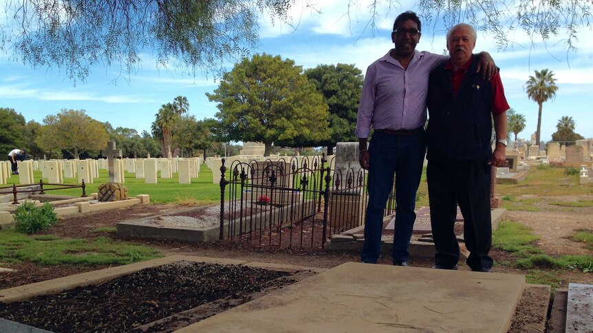 Miller Mack’s relatives, Herb Mack and Francis Lovegrove, at his grave.