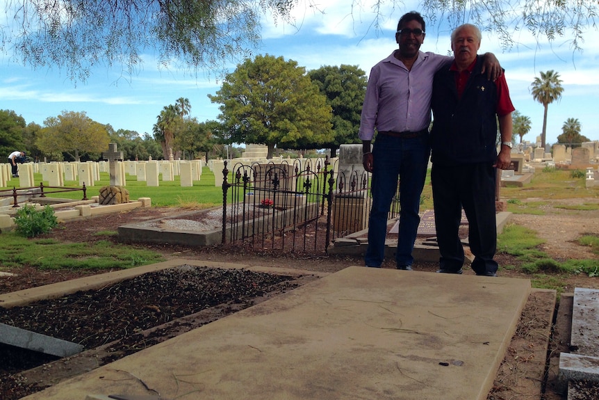 Miller Mack’s relatives, Herb Mack and Francis Lovegrove, at his grave.