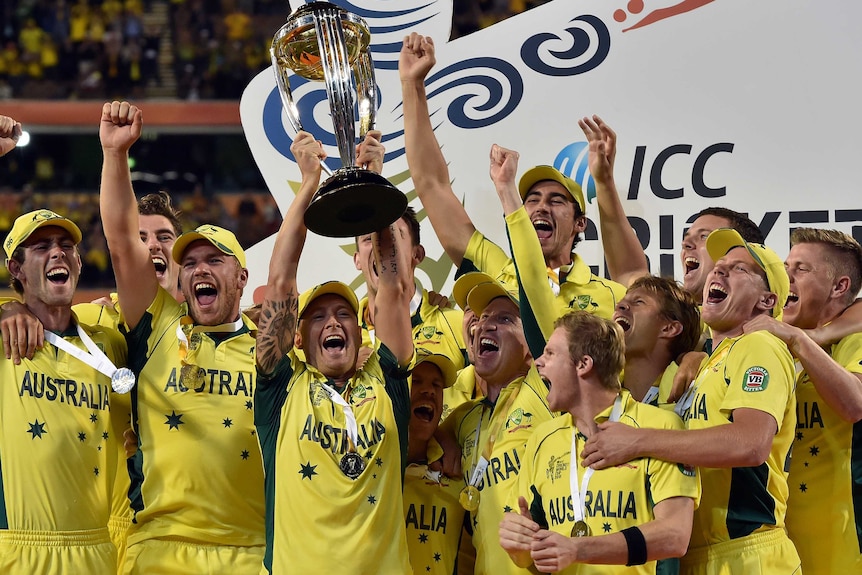 Cricket team celebrates winning a competition trophy.