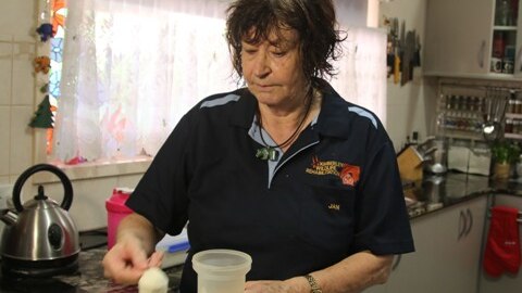 Jan Martin in her kitchen preparing food for the animals.