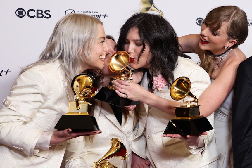 Lucy kisses her Grammy as Phoebe leans in and laughs as Taylor Swift ducks into the group photo as well.