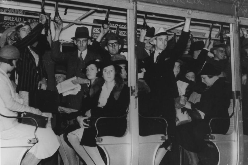 People sitting, standing on a Brisbane tram in 1937