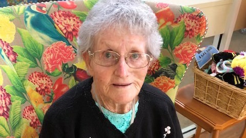 An older woman wearing glasses.