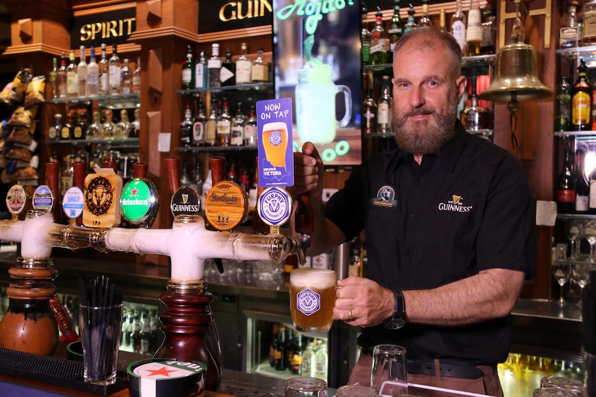 King O'Malley's owner Peter Barclay pours a beer.