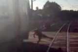 Video shows man's near miss at rail crossing