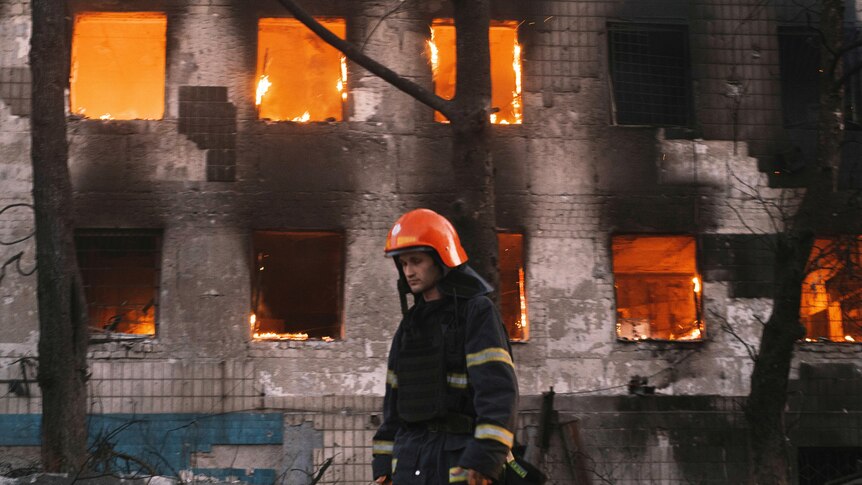 Firefighters work at the site of fire after Russian shelling