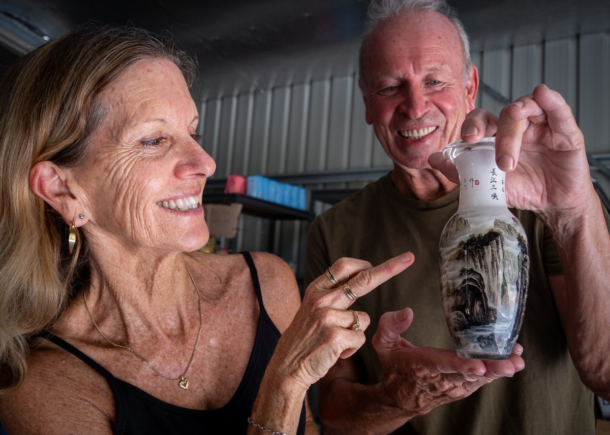 woman and man holding ornate glass urn