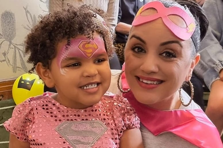 A woman and small girl dressed in pink super hero costumes, for a story on why The Wiggles new diverse members are so important.
