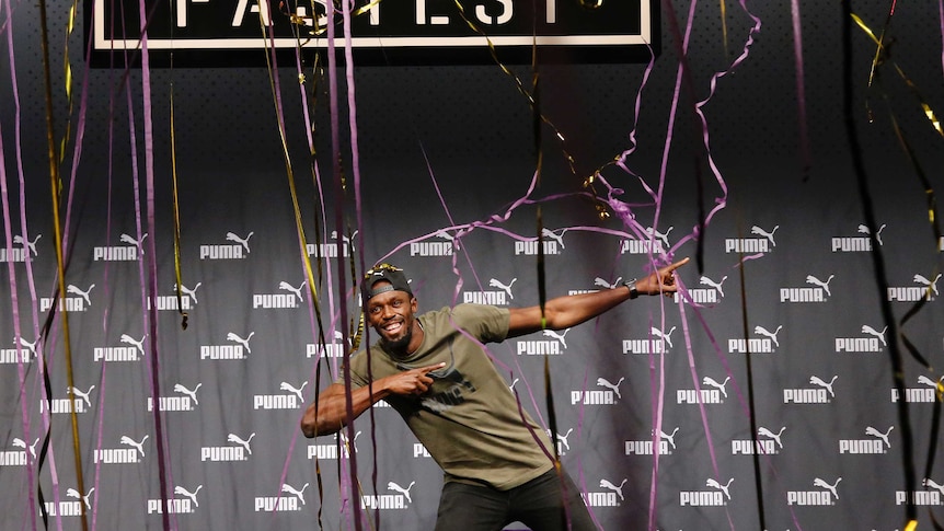 Jamaican athlete Usain Bolt celebrates after a press conference ahead of the World Athletics championships in London.