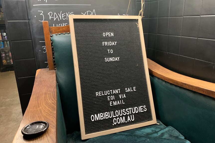 A sign in a bar saying it is reluctantly for sale.