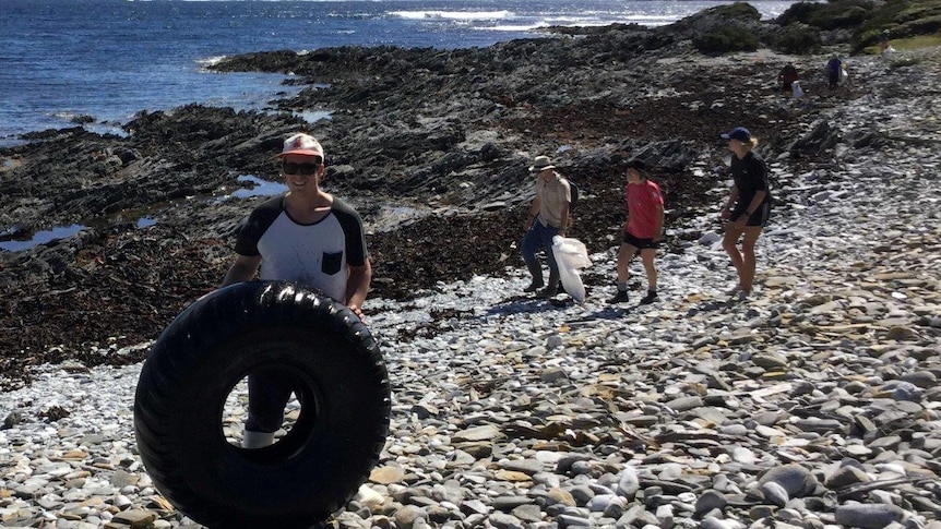 Volunteers collecting rubbish from a remote Tasmanian beach