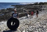Volunteers collecting rubbish from a remote Tasmanian beach