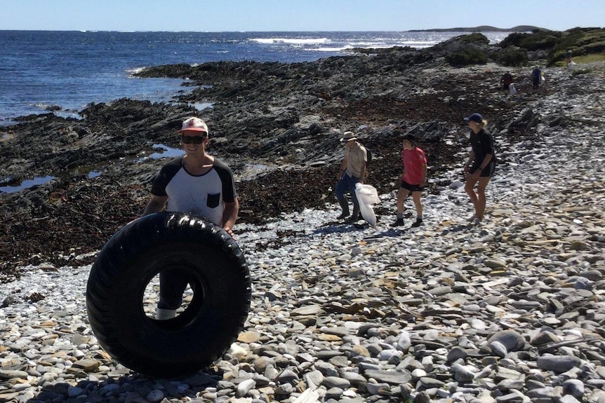 Volunteers collecting rubbish from a remote Tasmanian beach