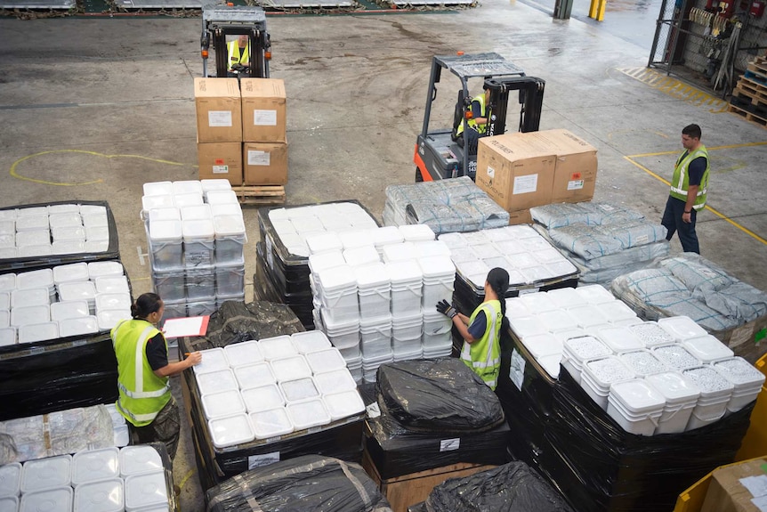 New Zealand Defence Force personnel prepare to load 12 tonnes of aid supplies for cyclone-hit Tonga