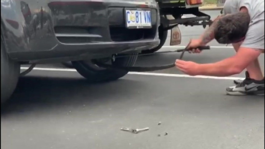A snake handler comes to the rescue of a woman whose ute had an unwanted passenger.