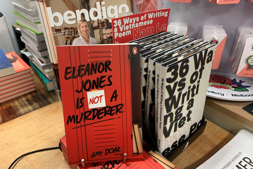 Copies of Eleanor Jones is Not a Murderer displayed on a counter in a bookshop.
