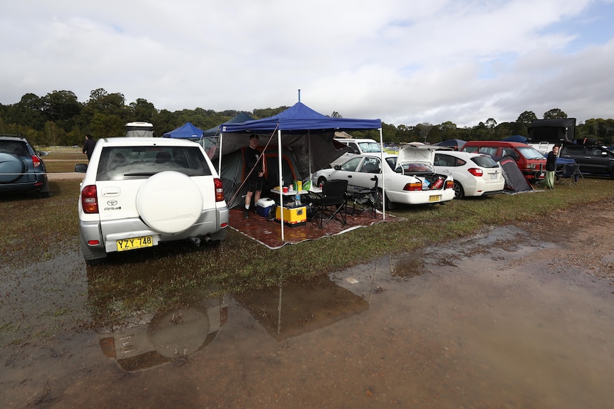 cars parked near a wet road at a campgrounds