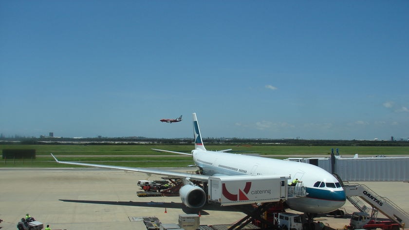 Jet parked next to airbridge at Brisbane international airport