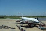 Jet parked next to airbridge at Brisbane international airport