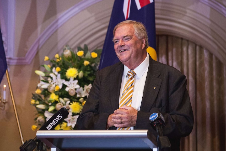 A smiling Kim Beazley stands at a podium, speaking about his appointment as WA's next Governor.