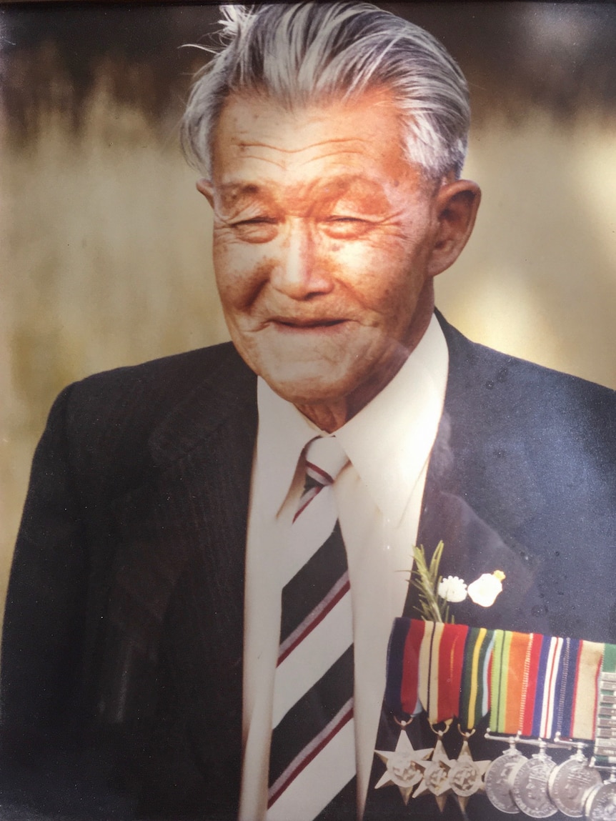 Portrait of Charles Yow Jr wearing a suit and displaying medals.