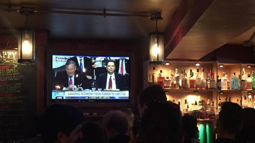 James Comey's testimony plays on the television at the Union Hotel in Washington DC.