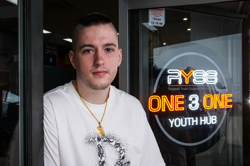 A young man standing outside a youth hub.