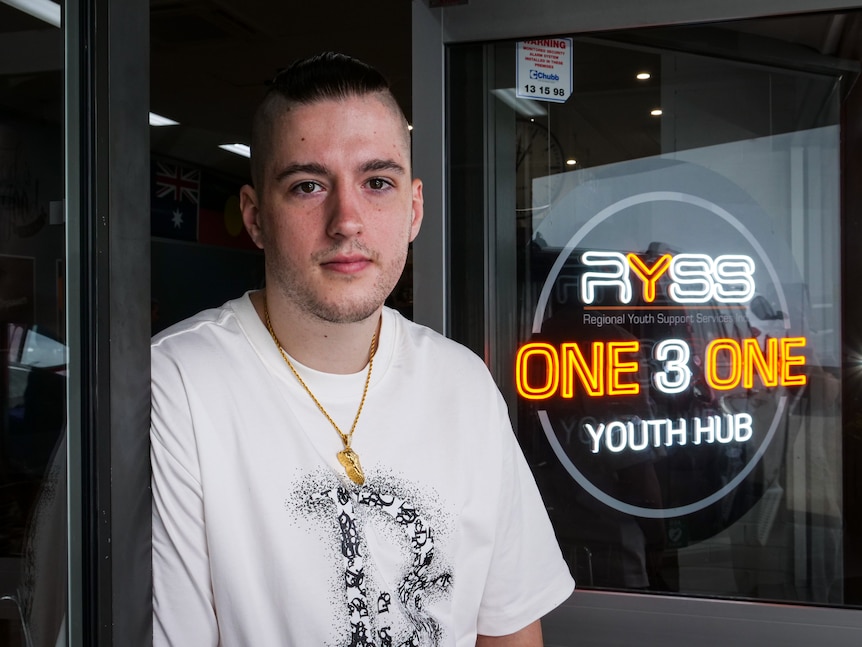 A young man standing outside a youth hub.