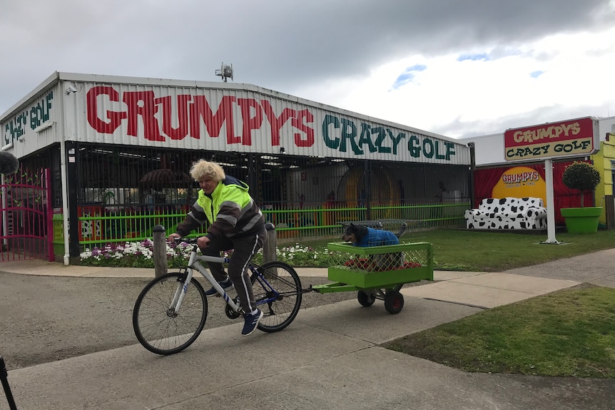 A man riding past Grumpys Crazy Golf business