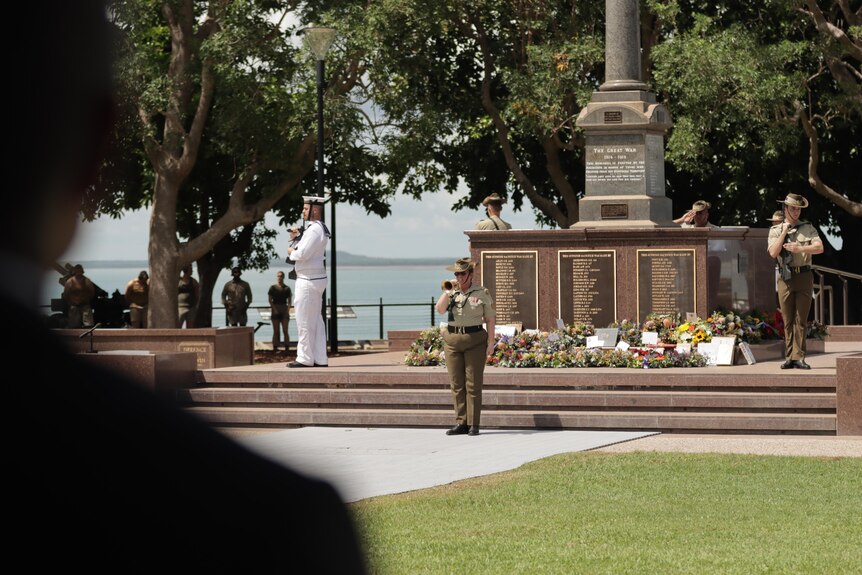A group of soldiers standing in formation around the Darwin Cenotaph.