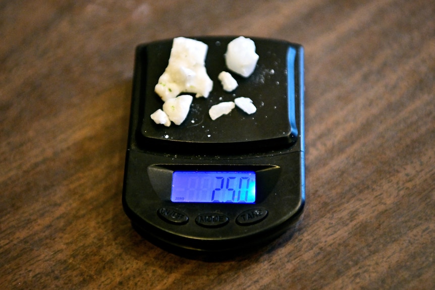 A 2.5 gram portion of rock cocaine is seen on a scale.