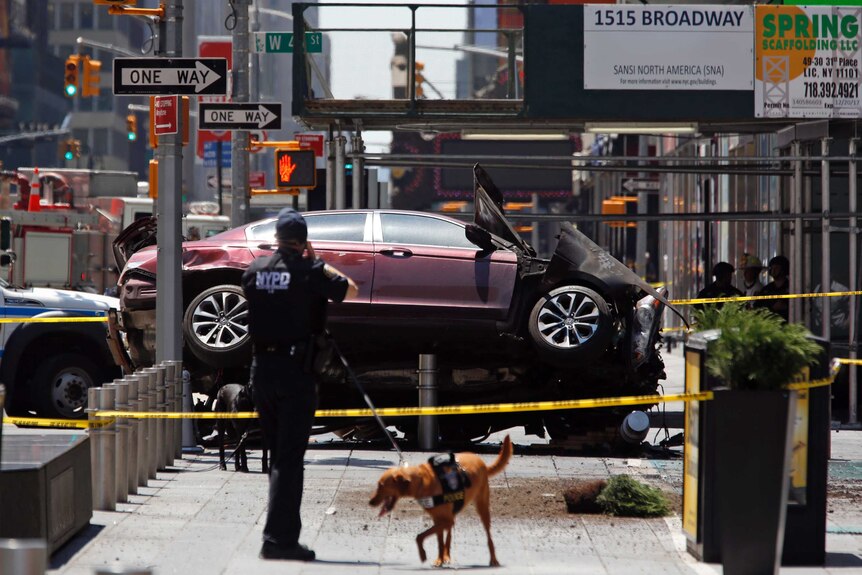 Authorities cordon off a crashed car in Times Square.