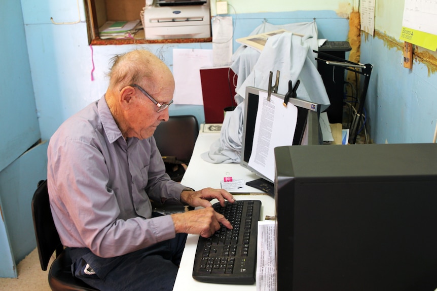 Hillston Spectator editor Patrick O'Sullivan trying at his desk