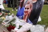 Floral tributes and candles are placed around a photo of slain Labour MP Jo Cox at a vigil.