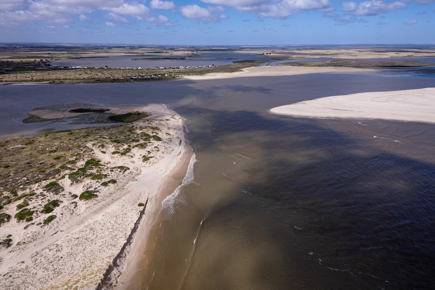 The end of a river with sand dunes