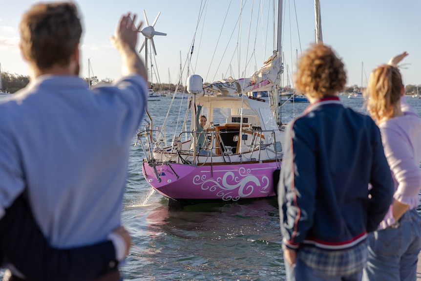 Teagan, as Jessica Watson, waves to her wave as she sets sail on the Pink Lady.