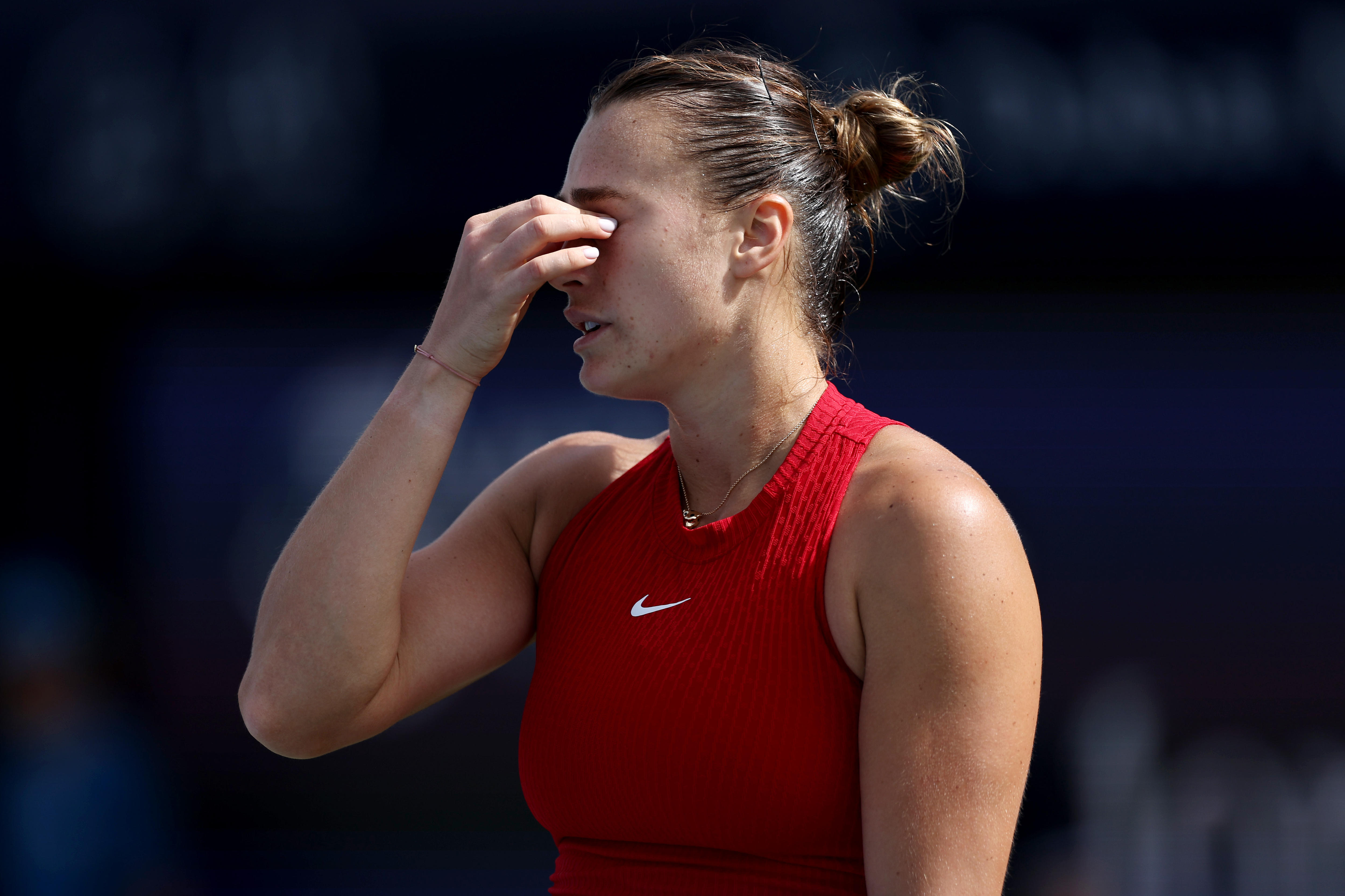 Aryna Sabalenka holds her nose during a match in Dubai as she shows her frustration.