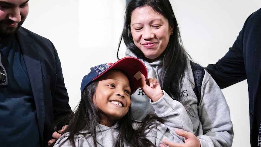 Vanessa Rodel looks down at her daughter Keana.