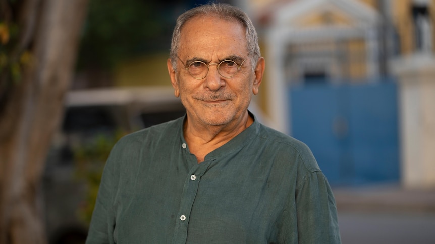 A man wearing glasses and a grey shirt